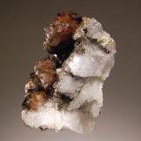 Scheelite
Yaogangxian Mine, Yizhang Co., Chenzhou Pref., Hunan Prov., China
4.0 x 4.5 cm
Lustrous brown scheelite crystals on a milky quartz matrix. (Author: crosstimber)