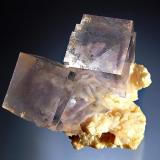 Fluorite
Shangbao Mine, Leiyang Co., Hunan Prov., China
4.5 x 5.0 cm
Pale blue cubic fluorite with purple phantoms resting on a matrix of pale beige dolomite crystals. (Author: crosstimber)