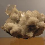 Heulandite + Chabazite + Mesolite
Moonen Bay, Isle of Skye, Scotland, UK
50mm x 30mm x 35mm high
I was not alone on Skye on this occasion: my friend Dave found a small cavity full of &rsquo;mesolite&rsquo; and when the &rsquo;mesolite&rsquo; was washed off, some nice heulandite crystals appeared, accompanied by chabazite. A lot of the chabazite occurs as tiny crystals growing on the &rsquo;mesolite&rsquo; needles, forming white globular masses. The main heulandite crystal measures 10mm x 8mm x 3mm thickness. Collected March/April 2013. (Author: Mike Wood)