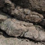 Close-up of the pegmatite vein pictured above. The vein is approx. 2ft (60cm) thick. Only the inner part is truly pegmatitic; the outer two parts of the vein are composed of either fine-grained granite, or aplite rock. But free grown crystals of quartz for example are very rarely found in these veins. (Author: Mike Wood)