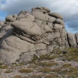 A typical pegmatite vein in the granite of Ben a’ Bhuird, this one is a bit larger than is usual for the locality, but was lacking in euhedral crystals.
 The outcrop is approximately 10m high. (Author: Mike Wood)