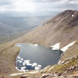 Lochan Uaine, about 1.5km southeast of Ben Macdui in the Cairngorms, one of the highest lochans (small lake) in the UK at over 950m above sea level. But even I was surprised to see icebergs floating on it, in late June!! Don&rsquo;t know for sure if it contains trout, but I bet it does.
Photo taken June 1994 (scanned from print), M.Wood. (Author: Mike Wood)