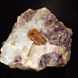 Fluorapatite
Fission Mine, Cardiff Township, Halliburton Co., Ontario, Canada
6.7 x 8.4 cm
A crystal of brown fluorapatite embedded in colorless calcite with purple fluorite. (Author: crosstimber)