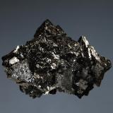 Hausmannite
N’Chwaning Mine, Kuruman, N. Cape Prov., South Africa
2.6 x 3.7 cm
An intergrown group of lustrous black hausmannite crystals to 2 cm on edge. (Author: crosstimber)
