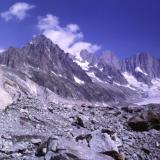 The way follows the Glacier de Leschaux for a little distance; where this glacier meets the Mer de Glace there are a lot of rocks about. (Lateral moraine?). I stopped to examine some of these boulders and found tiny crystals of pink fluorite in places.
Photo scanned from slide. (Author: Mike Wood)