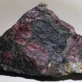 Eudialyte
Kola Peninsula, Rusia
9 x 6 x 4 cm
The other side of the same piece (with light matrix) on the previous photo. 

This is one of the classic minerals of alkaline sites. It looks like garnet but have a completely different composition and structure, its hardness is also considerably lower than garnet. (Author: kakov)