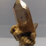 Smoky Quartz
Aiguille du Moine, Mont-Blanc massif, France
specimen 33mm tall
Smoky quartz crystal is 22mm tall x 15mm x 10mm, on a feldspar/granite matrix.
Found in a narrow cleft in the end of an old crystal cave, in 1991. (Author: Mike Wood)