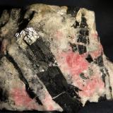 Arfvedsonite, Tugtupite, Albite
Ilímaussaq Intrusive Complex, Narsaq, Greenland
4,5 x 3,5 x 3 cm
Arfvedsonite is the typical amphibole of the intrusion. The best way to distinguish from Aegirine is through the strike colour that is more bluish for Arfvedsonite, while that of aegirine is clearly green-green. (Author: kakov)