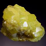 Sulfur
Racalmuto Mine, Agrigento Prov., Sicily, Italy
5.5 x 6.7 cm
Bright lemon yellow sulfur crystals associated with white aragonite crystals which exhibit pink fluorescence under LW and SW light. (Author: crosstimber)