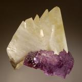 Calcite and fluorite
Elmwood, Carthage, Smith Co., Tennessee, USA
6.2 x 6.7 cm
Pale yellow calcite crystals in parallel growth with stepped cubes of light purple fluorite. (Author: crosstimber)