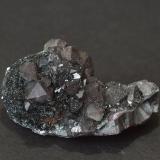 Quartz (var. smokey) on hematite (var. specularite) on plate
Haile Moor Mine, Haile, Egremont, Cumbria, England, UK
5.8 x 2.9 x 3.0 cm
other side (Author: captaincaveman)