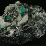 Beryl (variety emerald), Calcite<br />Coscuez mining district, Municipio San Pablo de Borbur, Western Emerald Belt, Boyacá Department, Colombia<br />95x75x75mm - main emerald xl=15mm<br /> (Author: Fiebre Verde)