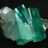 Beryl (variety emerald), Calcite<br />Muzo mining district, Western Emerald Belt, Boyacá Department, Colombia<br />Main crystal = 13mm<br /> (Author: Fiebre Verde)