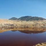 The Berkeley Pit was opened in 1955 and closed in 1982. It is 1,780 feet deep and is filled to a depth of 975  feet with acidic water. (Author: crosstimber)