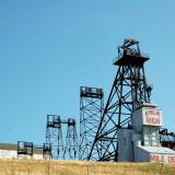 The Mountain Consolidated, or Mt. Con, was the deepest mine at Butte. The main shaft was 5,380 feet deep, and because of its depth, it was a very hot mine to work in. It produced excellent specimens of bornite chalcocite, enargite, and pyrite. (Author: crosstimber)