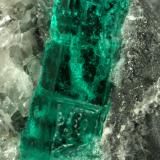 Beryl (variety emerald), Calcite<br />La Pita mining district, Municipio Maripí, Western Emerald Belt, Boyacá Department, Colombia<br />40mm across, xl=15mm<br /> (Author: Fiebre Verde)