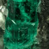 Beryl (variety emerald), Calcite<br />La Pita mining district, Municipio Maripí, Western Emerald Belt, Boyacá Department, Colombia<br />40mm across, xl=15mm<br /> (Author: Fiebre Verde)