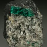 Beryl (variety emerald), Calcite<br />La Pita mining district, Municipio Maripí, Western Emerald Belt, Boyacá Department, Colombia<br />40mm across, xl=15mm<br /> (Author: Fiebre Verde)