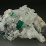 Beryl (variety emerald), Calcite, Parisite<br />Muzo mining district, Western Emerald Belt, Boyacá Department, Colombia<br />70x45x50mm<br /> (Author: Fiebre Verde)