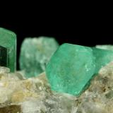 Beryl (variety emerald), Calcite<br />Chivor mining district, Municipio Chivor, Eastern Emerald Belt, Boyacá Department, Colombia<br />Crystals are about 1cm long<br /> (Author: Fiebre Verde)