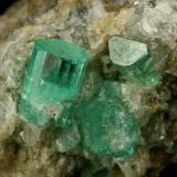 Beryl (variety emerald), Calcite<br />Chivor mining district, Municipio Chivor, Eastern Emerald Belt, Boyacá Department, Colombia<br />Crystals are about 1cm long<br /> (Author: Fiebre Verde)