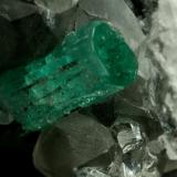 Beryl (variety emerald), Calcite, QuartzLa Pita (distrito minero), Municipio Maripí, Cinturón Esmeraldífero Occidental, Departamento Boyacá, ColombiaEmerald crystal is 11mm long (Author: Fiebre Verde)
