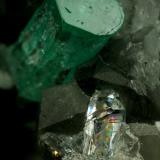 Beryl (variety emerald), Calcite, Quartz<br />La Pita mining district, Municipio Maripí, Western Emerald Belt, Boyacá Department, Colombia<br />Emerald crystal is 11mm long<br /> (Author: Fiebre Verde)