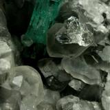 Beryl (variety emerald), Calcite, QuartzLa Pita (distrito minero), Municipio Maripí, Cinturón Esmeraldífero Occidental, Departamento Boyacá, ColombiaEmerald crystal is 11mm long (Author: Fiebre Verde)