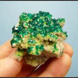 Dioptase on calcite.<br />Tsumeb Mine, Tsumeb, Otjikoto Region, Namibia<br />52 x 47 x 30 mm<br /> (Author: Pierre Joubert)