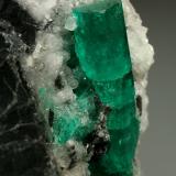 Beryl (variety emerald), Calcite<br />Muzo mining district, Western Emerald Belt, Boyacá Department, Colombia<br />28x51x49mm, xl=30mm<br /> (Author: Fiebre Verde)