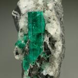 Beryl (variety emerald), Calcite<br />Muzo mining district, Western Emerald Belt, Boyacá Department, Colombia<br />28x51x49mm, xl=30mm<br /> (Author: Fiebre Verde)