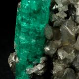 Beryl (variety emerald), Calcite<br />La Pita mining district, Polveros Mine, Municipio Maripí, Western Emerald Belt, Boyacá Department, Colombia<br />37x45mm, xl=34mm<br /> (Author: Fiebre Verde)