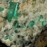 Beryl (variety emerald), Calcite, Aragonite<br />Chivor mining district, Municipio Chivor, Eastern Emerald Belt, Boyacá Department, Colombia<br />80x70x65mm, main xl=18mm<br /> (Author: Fiebre Verde)