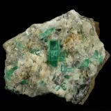 Beryl (variety emerald), Calcite, Aragonite<br />Chivor mining district, Municipio Chivor, Eastern Emerald Belt, Boyacá Department, Colombia<br />80x70x65mm, main xl=18mm<br /> (Author: Fiebre Verde)