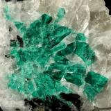 Beryl (variety emerald), Calcite<br />La Pita mining district, Municipio Maripí, Western Emerald Belt, Boyacá Department, Colombia<br />7cm across<br /> (Author: Fiebre Verde)