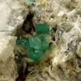 Beryl (variety emerald), Calcite, Aragonite<br />Chivor mining district, Municipio Chivor, Eastern Emerald Belt, Boyacá Department, Colombia<br />75x55x65mm, main xl~1cm<br /> (Author: Fiebre Verde)