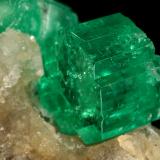 Beryl (variety emerald), Calcite<br />Muzo mining district, Western Emerald Belt, Boyacá Department, Colombia<br />60x47x49mm, central xl=16mm<br /> (Author: Fiebre Verde)