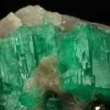 Beryl (variety emerald), Calcite<br />Muzo mining district, Western Emerald Belt, Boyacá Department, Colombia<br />60x47x49mm, central xl=16mm<br /> (Author: Fiebre Verde)