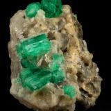 Beryl (variety emerald), Calcite<br />Muzo mining district, Western Emerald Belt, Boyacá Department, Colombia<br />60x47x49mm, central xl=16mm<br /> (Author: Fiebre Verde)