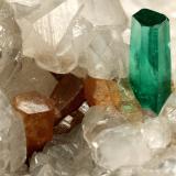 Beryl (variety emerald), Calcite, Parisite<br />La Pita mining district, Municipio Maripí, Western Emerald Belt, Boyacá Department, Colombia<br />8x8x8cm, H35mm, xl=8mm<br /> (Author: Fiebre Verde)