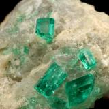 Beryl (variety emerald), Calcite<br />La Pita mining district, Cunas Mine, Municipio Maripí, Western Emerald Belt, Boyacá Department, Colombia<br />42x39x34mm, xls up to 7mm<br /> (Author: Fiebre Verde)