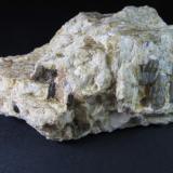 Pegmatita
Mina Nibbio mine, Mergozzo, Verbano-Cusio-Ossola Province, Piedmont, Italia
10 x 5 cm.
Pegmatita de feldespato con los accesorios: un zircón (pequeño y oscuro, abajo a la izquierda) y sillimanita azulada (a la derecha, cristales verticales). (Autor: prcantos)