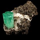 Beryl (variety emerald), Calcite, Parisite, Aragonite(?)<br />Muzo mining district, Western Emerald Belt, Boyacá Department, Colombia<br />38x40x31mm, xl=15x10mm<br /> (Author: Fiebre Verde)