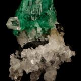 Beryl (variety emerald), Calcite, Quartz<br />Muzo mining district, Western Emerald Belt, Boyacá Department, Colombia<br />53x39mm, xl=25x23mm<br /> (Author: Fiebre Verde)