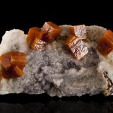 Wulfenite on Calcite<br />Erupción Mine (Ahumada Mine), Los Lamentos Mountain Range, Municipio Ahumada, Chihuahua, Mexico<br />10,5	x	4,5	x	4,5	cm<br /> (Author: MIM Museum)